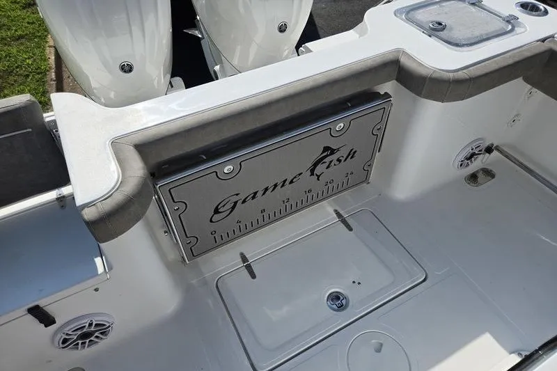 Slide: The Image of 2026 Sea Hunt Gamefish 25 boat deck with measuring board and storage compartments. - 22