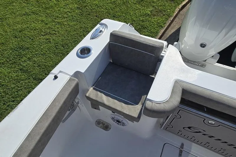 Slide: The Image of 2026 Sea Hunt Gamefish 25 boat interior with cushioned seating and cup holders. - 27