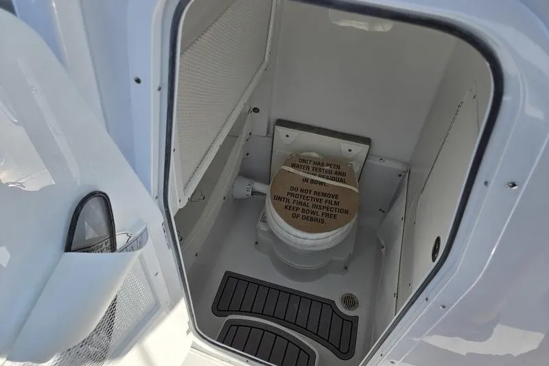 Slide: The Image of Interior of 2026 Sea Hunt Gamefish 25 boat with compact marine toilet. - 15