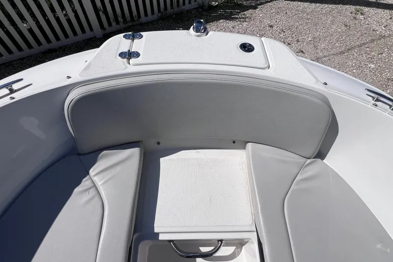 Slide: The Image of 2022 Sea Ray SPX 210 Outboard boat interior with gray seating and storage compartment. - 29