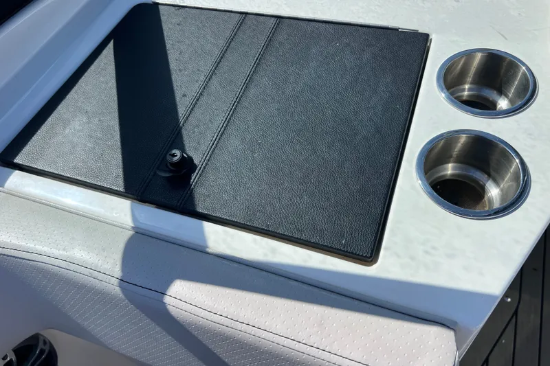Slide: The Image of 2022 Sea Ray SPX 210 Outboard boat interior with cup holders and storage compartment. - 37