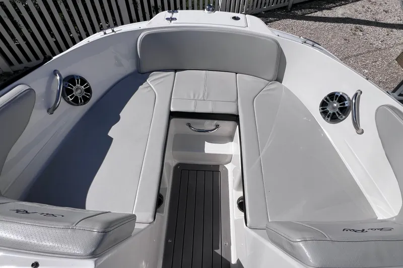 Slide: The Image of 2022 Sea Ray SPX 210 Outboard boat interior with gray seating and speakers. - 27