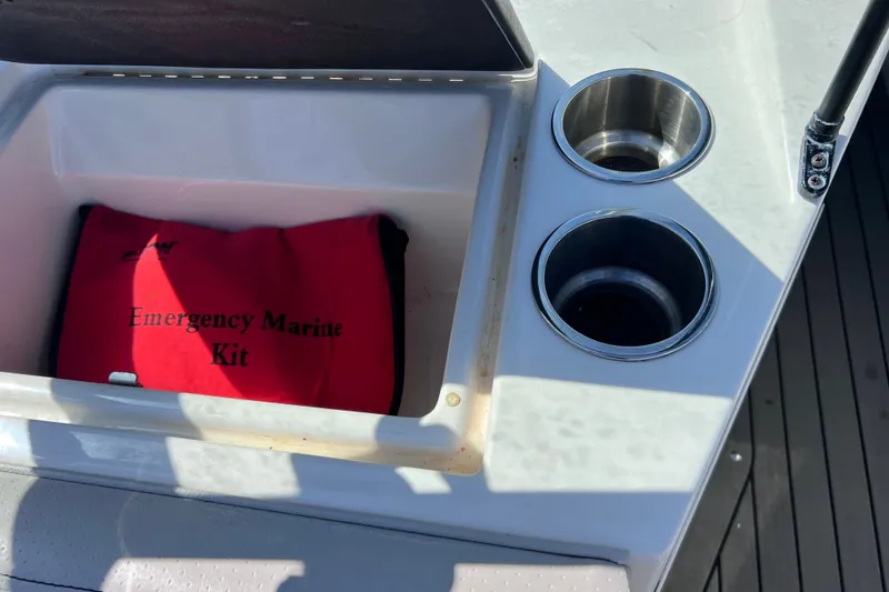 Slide: The Image of 2022 Sea Ray SPX 210 Outboard with emergency marine kit and cup holders. - 38