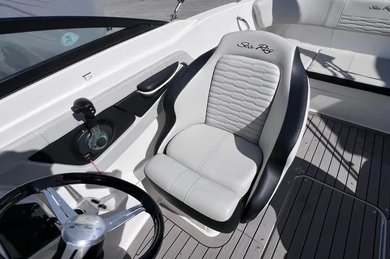 Slide: The Image of 2022 Sea Ray SPX 210 Outboard cockpit with steering wheel and comfortable seating. - 20