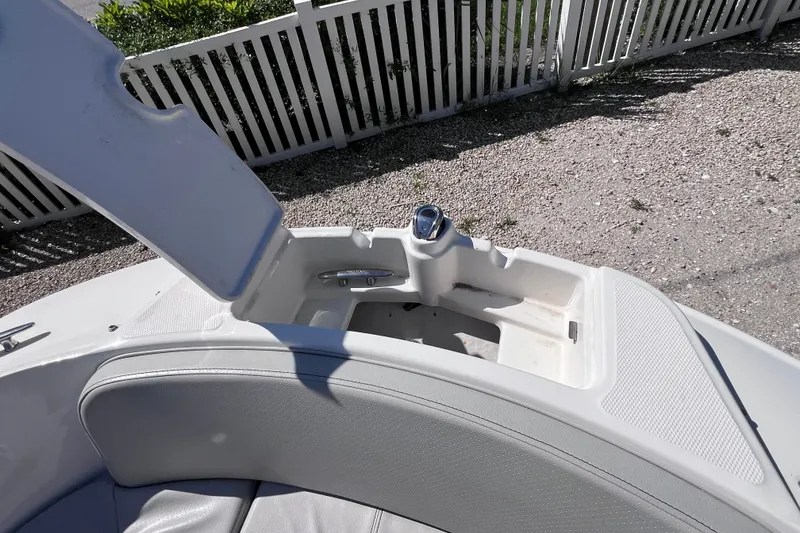 Slide: The Image of 2022 Sea Ray SPX 210 Outboard boat interior storage compartment with open lid. - 30
