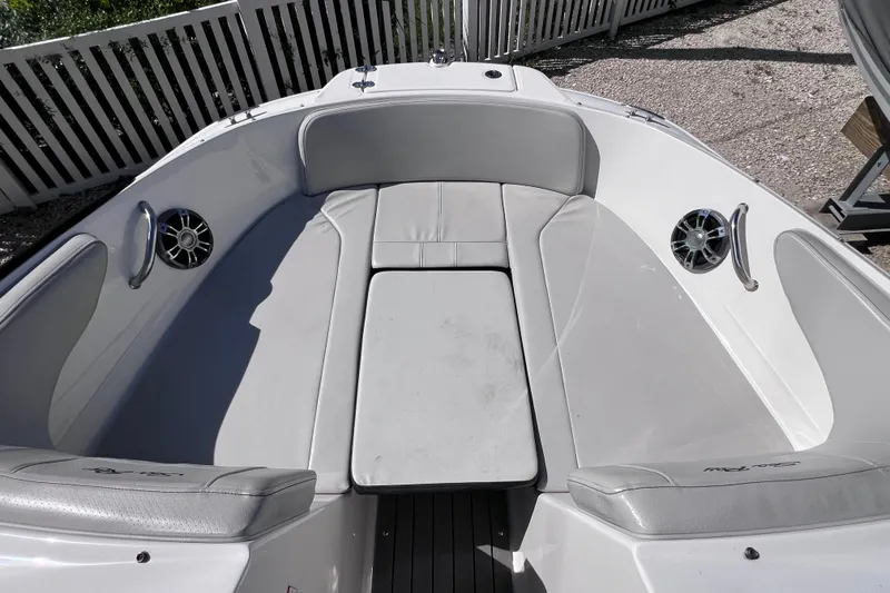 Slide: The Image of 2022 Sea Ray SPX 210 Outboard boat interior with cushioned seating and speakers. - 26