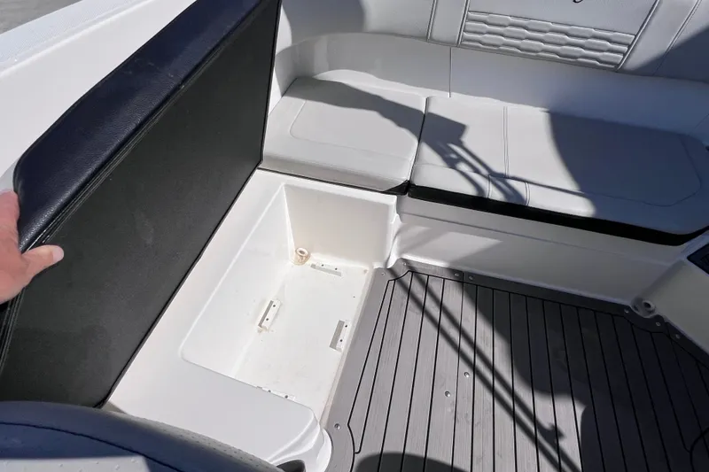 Slide: The Image of 2022 Sea Ray SPX 210 Outboard boat interior with open storage compartment. - 15