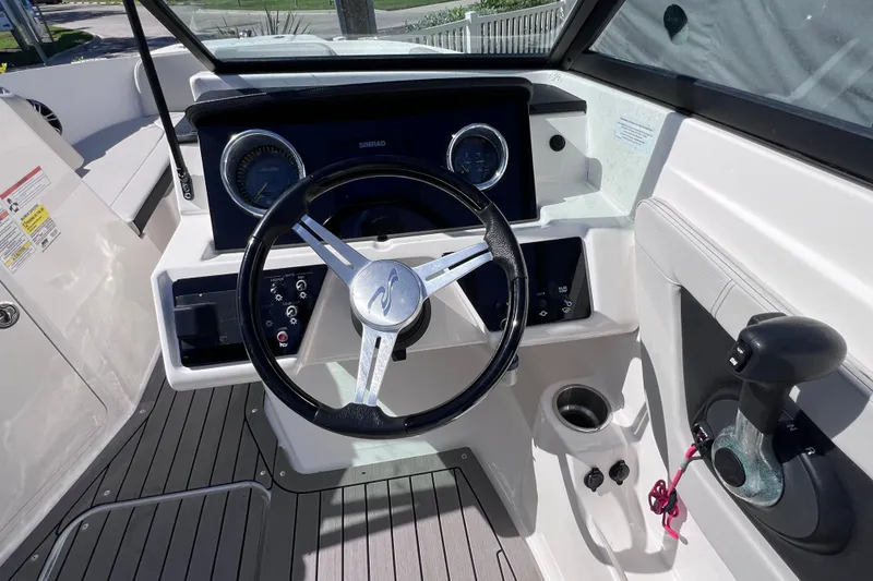 Slide: The Image of 2022 Sea Ray SPX 210 Outboard boat dashboard with steering wheel and controls. - 21