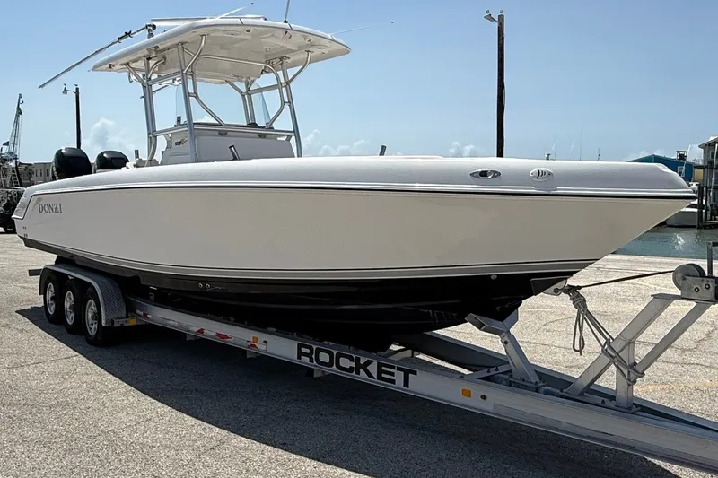 Slide: The Image of 2010 Donzi 32 ZF boat on a trailer at a marina, ready for launch. - 4