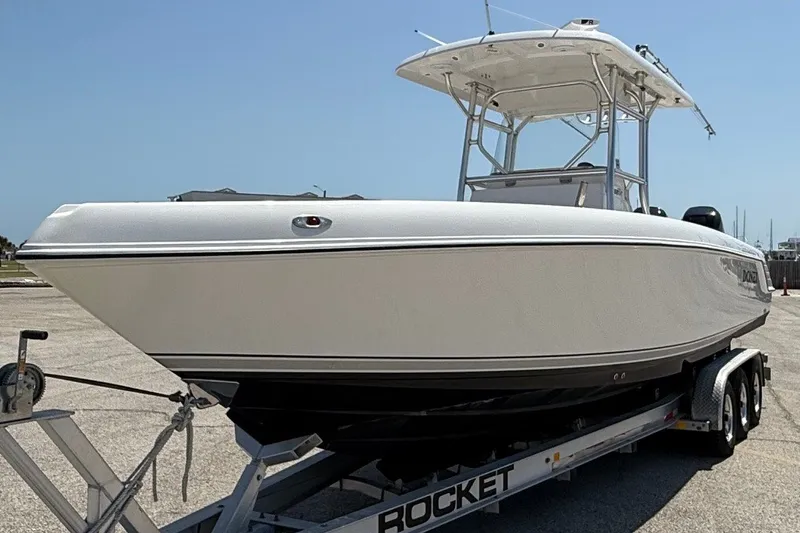 Slide: The Image of 2010 Donzi 32 ZF boat on trailer, parked outdoors under clear sky. - 5