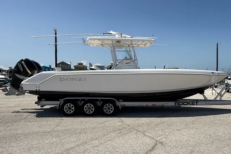 The Image of 2010 Donzi 32 ZF boat on trailer, side view, clear sky background. - 0
