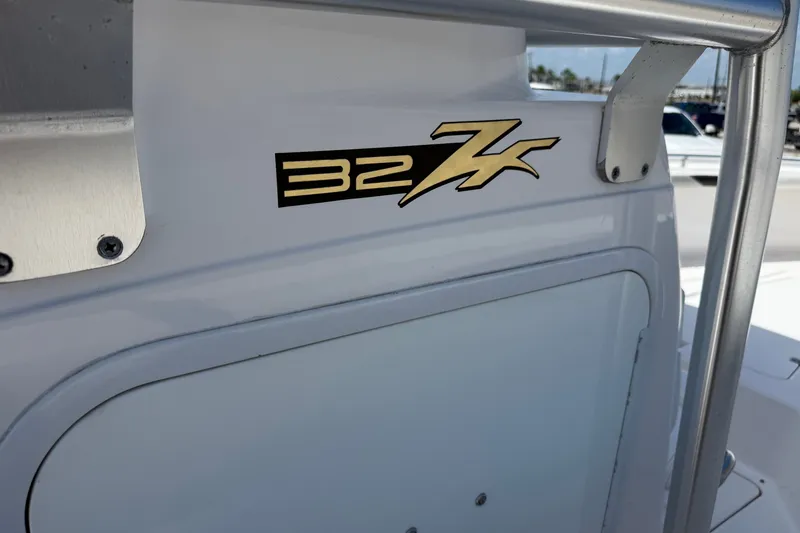 Slide: The Image of 2010 Donzi 32 ZF boat logo on white surface with metal railing. - 18