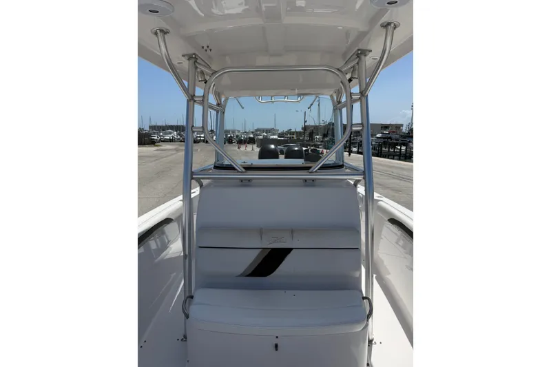 Slide: The Image of 2010 Donzi 32 ZF boat interior with seating and metal framework, dockside view. - 15