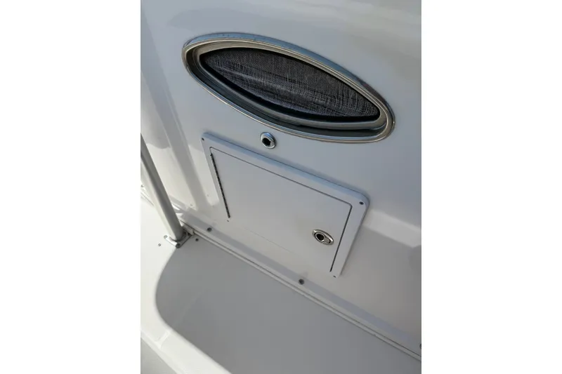 Slide: The Image of 2010 Donzi 32 ZF boat interior detail with storage compartment and oval vent. - 7