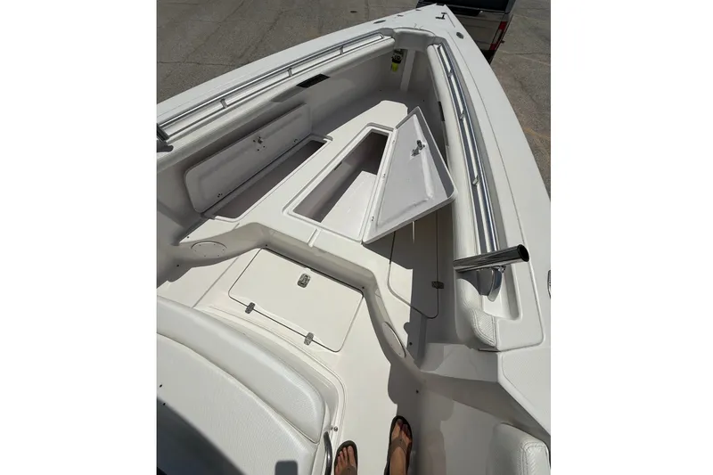 Slide: The Image of 2010 Donzi 32 ZF boat interior with open storage compartments and sleek design. - 8