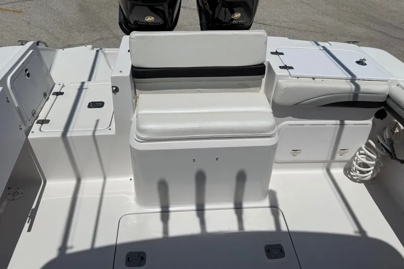 Slide: The Image of 2010 Donzi 32 ZF boat interior with white seating and storage compartments. - 10
