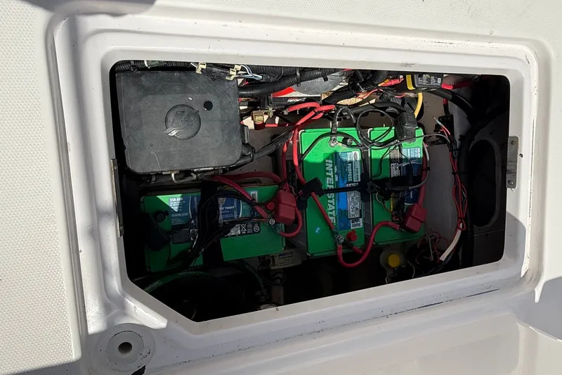 Slide: The Image of Battery compartment of a 2010 Donzi 32 ZF boat, featuring multiple batteries and wiring. - 20