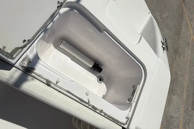 Slide: The Image of Open storage compartment on a 2010 Donzi 32 ZF boat, showing interior details. - 12