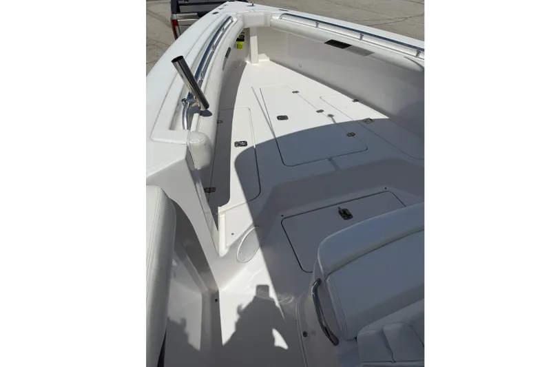 Slide: The Image of 2010 Donzi 32 ZF boat interior with white seating and storage compartments. - 16