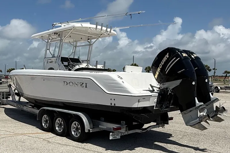 Slide: The Image of 2010 Donzi 32 ZF boat on trailer with twin Mercury engines, parked outdoors. - 3