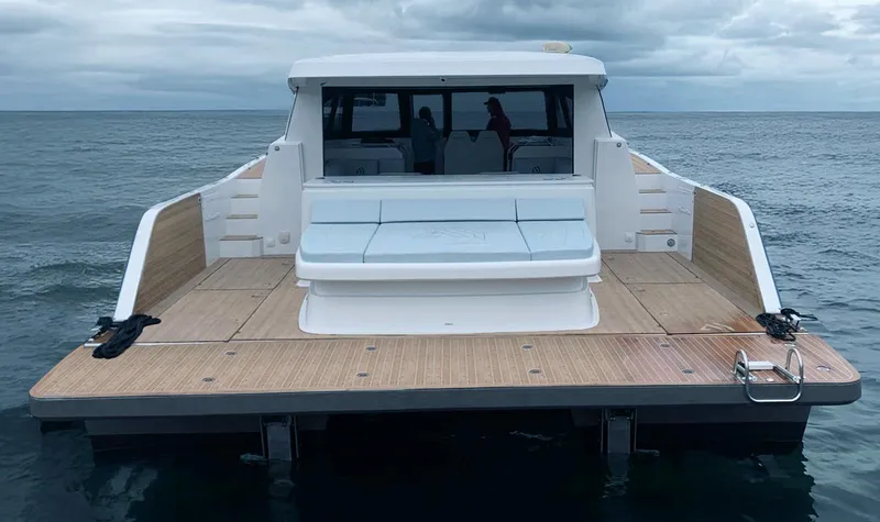 Slide: The Image of Aventura 38 Sport Coupe 2025 on open water, showcasing spacious deck and modern design. - 2