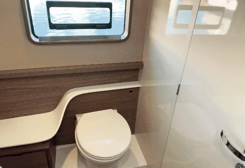 Slide: The Image of 2025 Aventura 38 Sport Coupe bathroom with modern design and window view. - 7