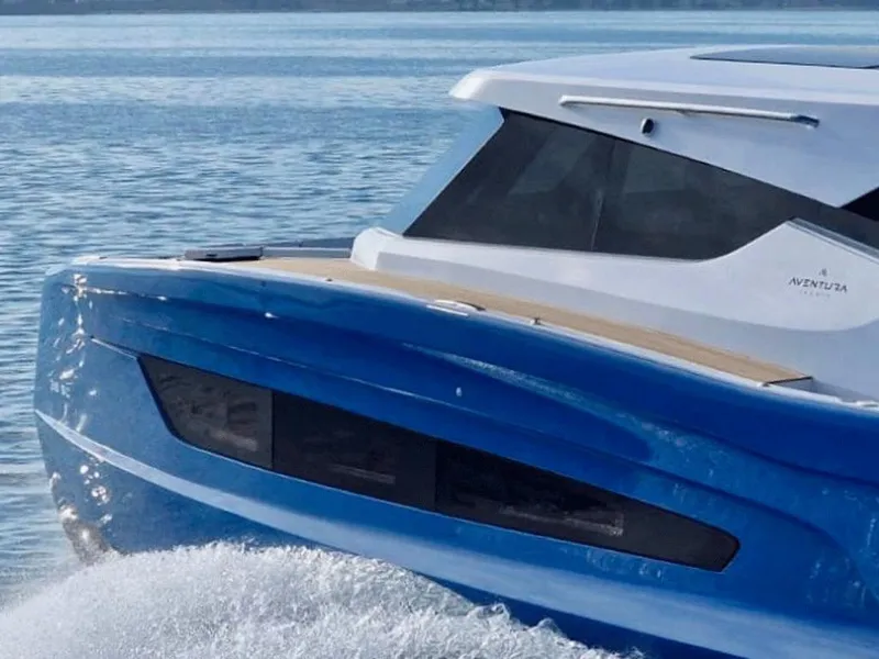 Slide: The Image of 2025 Aventura 38 Sport Coupe cruising on water, showcasing sleek blue design. - 4