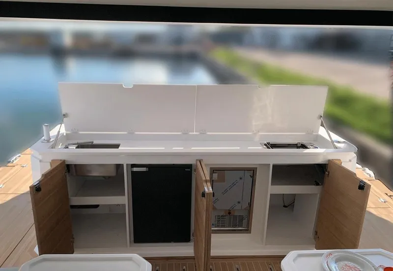 Slide: The Image of Outdoor kitchen on 2025 Aventura 38 Sport Coupe yacht, featuring sink and storage cabinets. - 6
