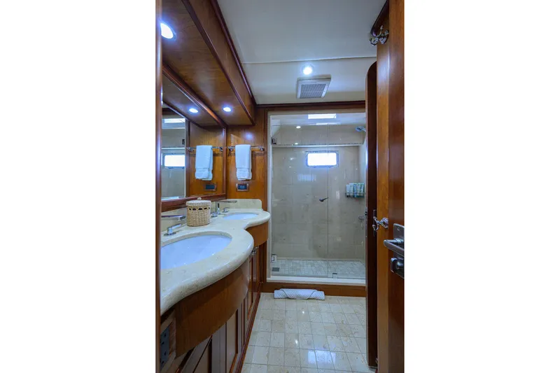 Slide: The Image of Luxurious bathroom in 2008 Outer Reef Yachts 800 Motoryacht, featuring elegant wood finishes and modern amenities. - 23