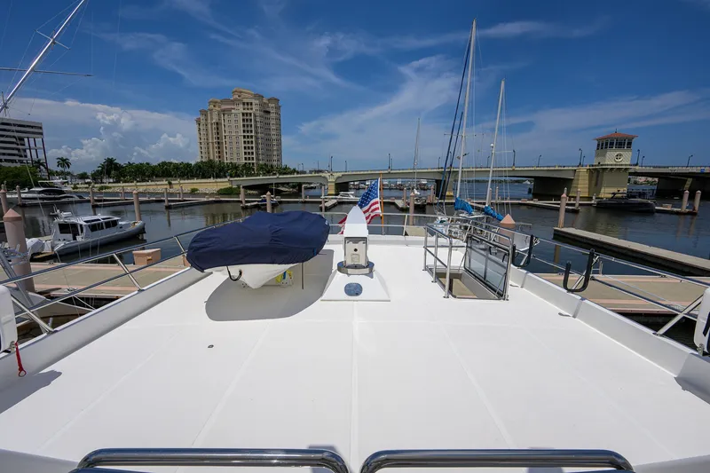 Slide: The Image of 2008 Outer Reef Yachts 800 Motoryacht docked at marina with cityscape background. - 36