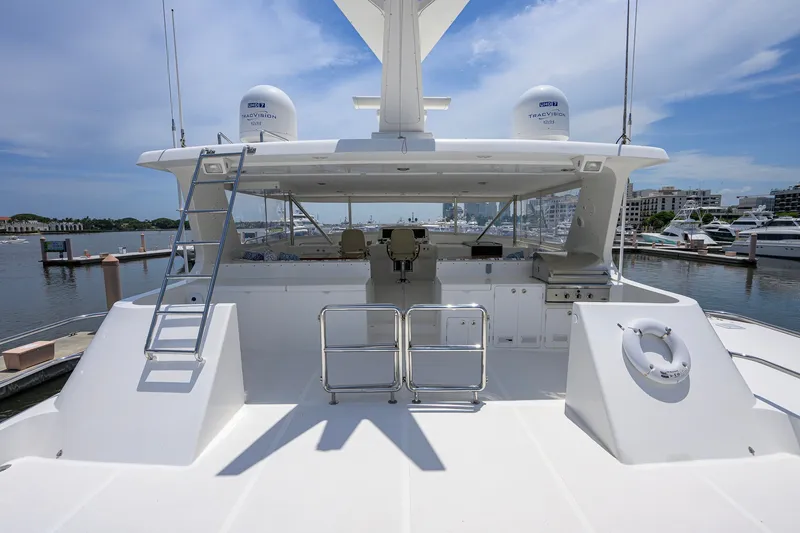 Slide: The Image of 2008 Outer Reef Yachts 800 Motoryacht deck with helm, ladder, and marina view. - 35