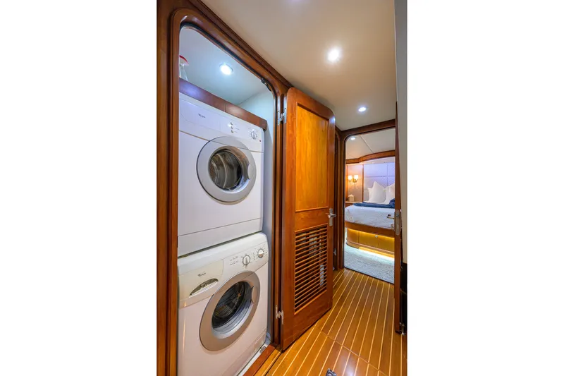 Slide: The Image of Laundry area with stacked washer and dryer on 2008 Outer Reef Yachts 800 Motoryacht. - 26