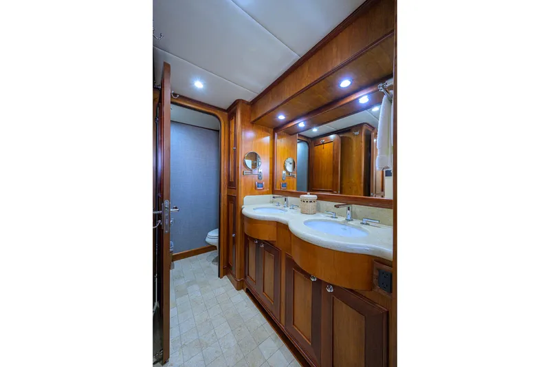 Slide: The Image of Luxurious bathroom in 2008 Outer Reef Yachts 800 Motoryacht with dual sinks and wooden cabinetry. - 25