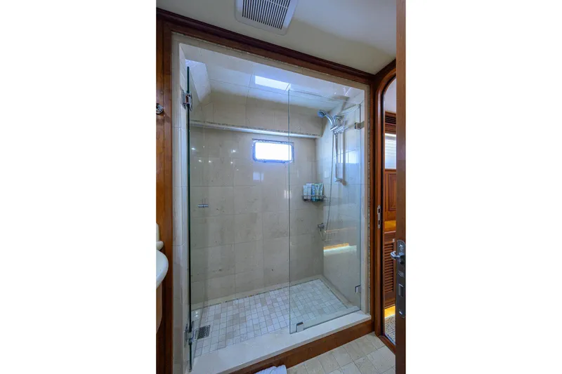 Slide: The Image of Luxurious shower in 2008 Outer Reef Yachts 800 Motoryacht, featuring glass enclosure and elegant tilework. - 24