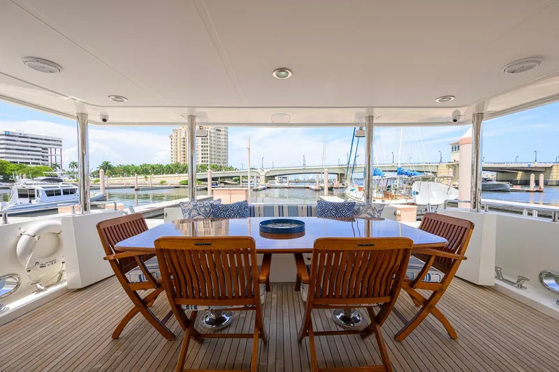 Slide: The Image of Outdoor dining area on 2008 Outer Reef Yachts 800 Motoryacht, overlooking marina and bridge. - 32