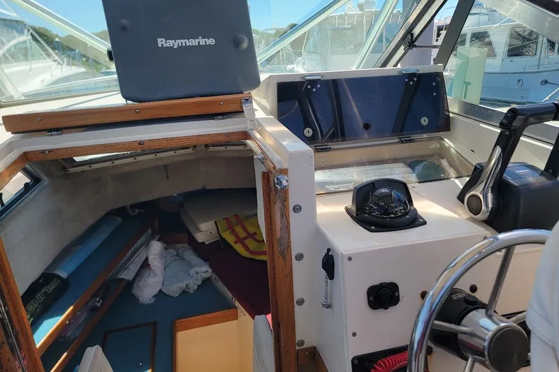 Slide: The Image of Interior of a 1985 Grady-White Offshore Pro 247 boat with navigation equipment. - 2