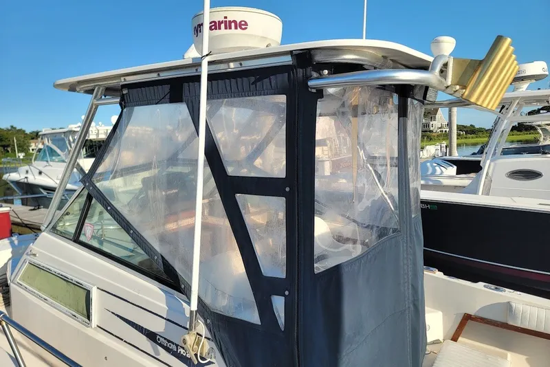 Slide: The Image of 1985 Grady-White Offshore Pro 247 boat with enclosed cabin at marina. - 11