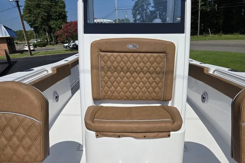 Slide: The Image of 2027 Sea Hunt Ultra 275SE boat interior with brown diamond-stitched seating. - 9