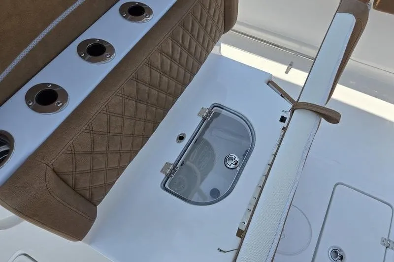Slide: The Image of 2027 Sea Hunt Ultra 275SE boat interior with rod holders and storage compartment. - 19