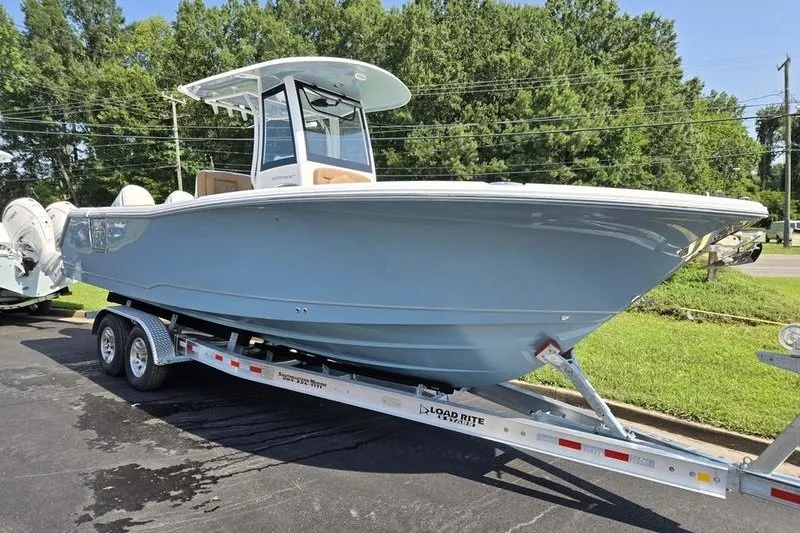 The Image of 2027 Sea Hunt Ultra 275SE boat on trailer, parked outdoors. - 1