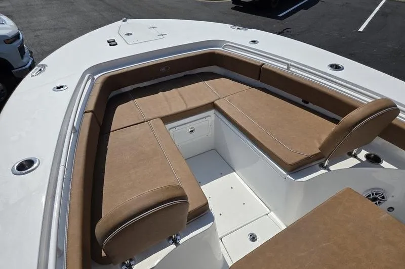 Slide: The Image of 2027 Sea Hunt Ultra 275SE boat with spacious tan seating area. - 2
