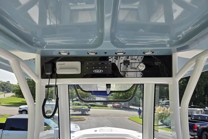 Slide: The Image of 2027 Sea Hunt Ultra 275SE boat console with electronics and overhead storage. - 21