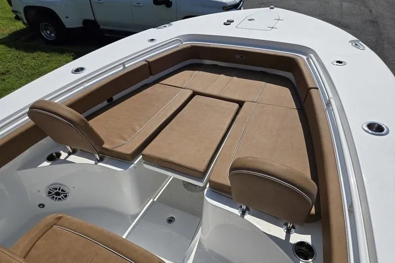 Slide: The Image of 2027 Sea Hunt Ultra 275SE boat with tan cushioned seating and sleek white deck. - 4