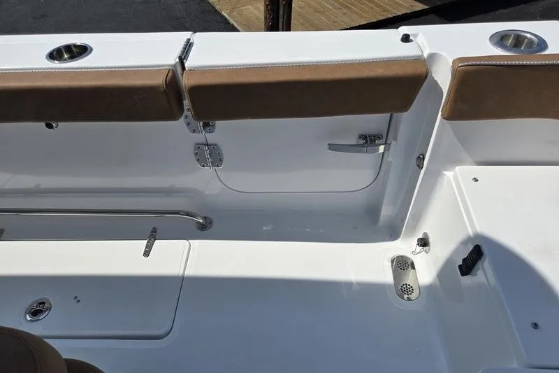 Slide: The Image of Interior view of 2027 Sea Hunt Ultra 275SE boat, featuring cushioned seating and stainless steel fixtures. - 15