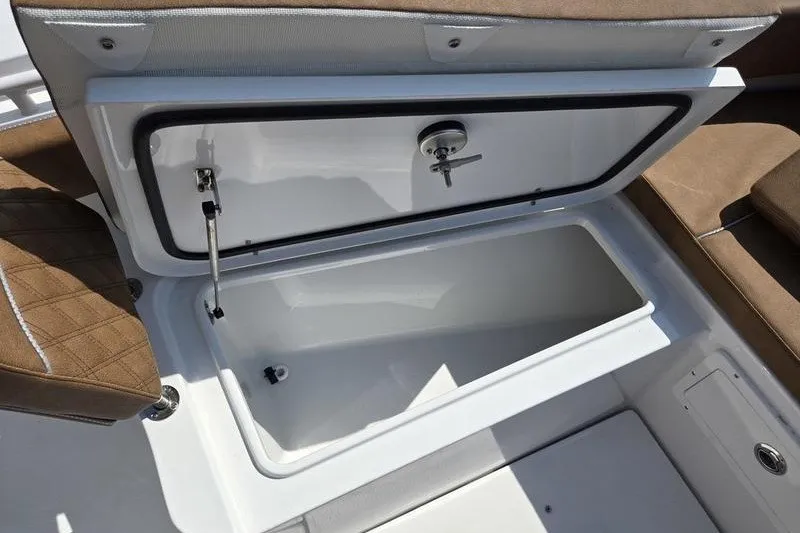 Slide: The Image of Storage compartment on a 2027 Sea Hunt Ultra 275SE boat, featuring cushioned seating. - 24