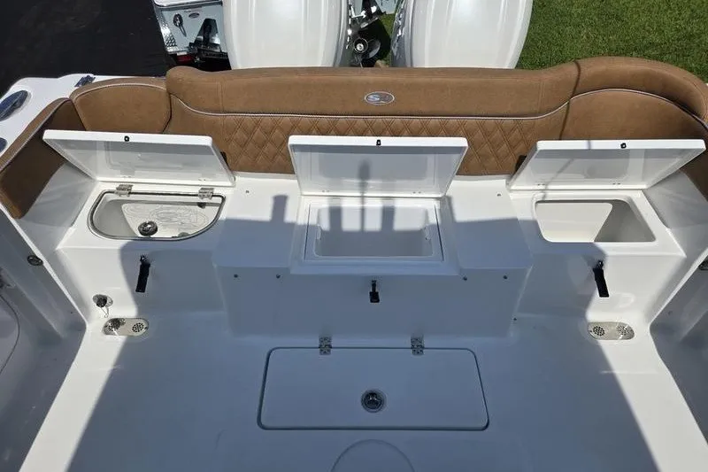 Slide: The Image of 2027 Sea Hunt Ultra 275SE boat interior with open storage compartments. - 23
