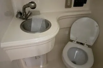 Slide: The Image of 2006 Larson Cabrio 260 boat bathroom with sink and toilet. - 32