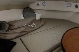 Slide: The Image of 2006 Larson Cabrio 260 cabin interior with beige upholstery and round table. - 29