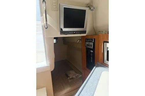 Slide: The Image of 2006 Larson Cabrio 260 cabin interior with TV and control panel. - 31