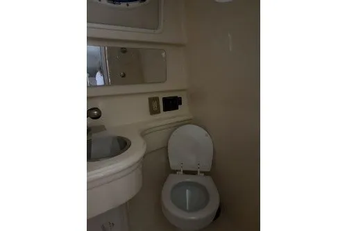 Slide: The Image of 2006 Larson Cabrio 260 boat bathroom with sink, mirror, and toilet. - 33